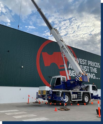 An ATF-40 Tonne All Terrain Tadano Crane with BT Access Group branding being outside a Bunnings store